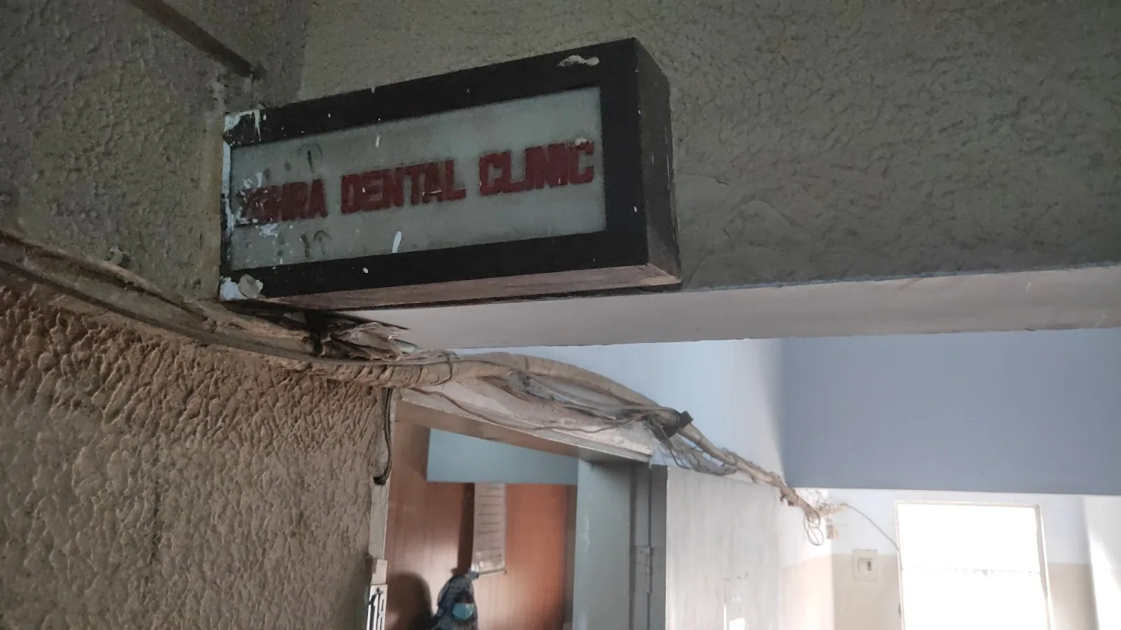 The clinic's red ZOHRA DENTAL CLINIC lightbox sign above Office 18